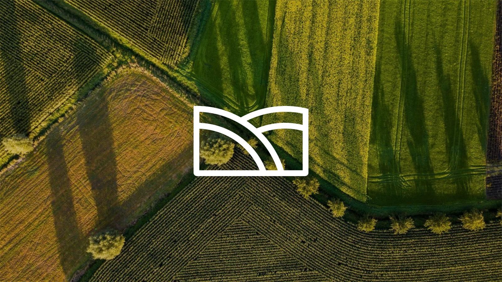 Open fields under a clear sky, representing land and activities regulated through environmental permits